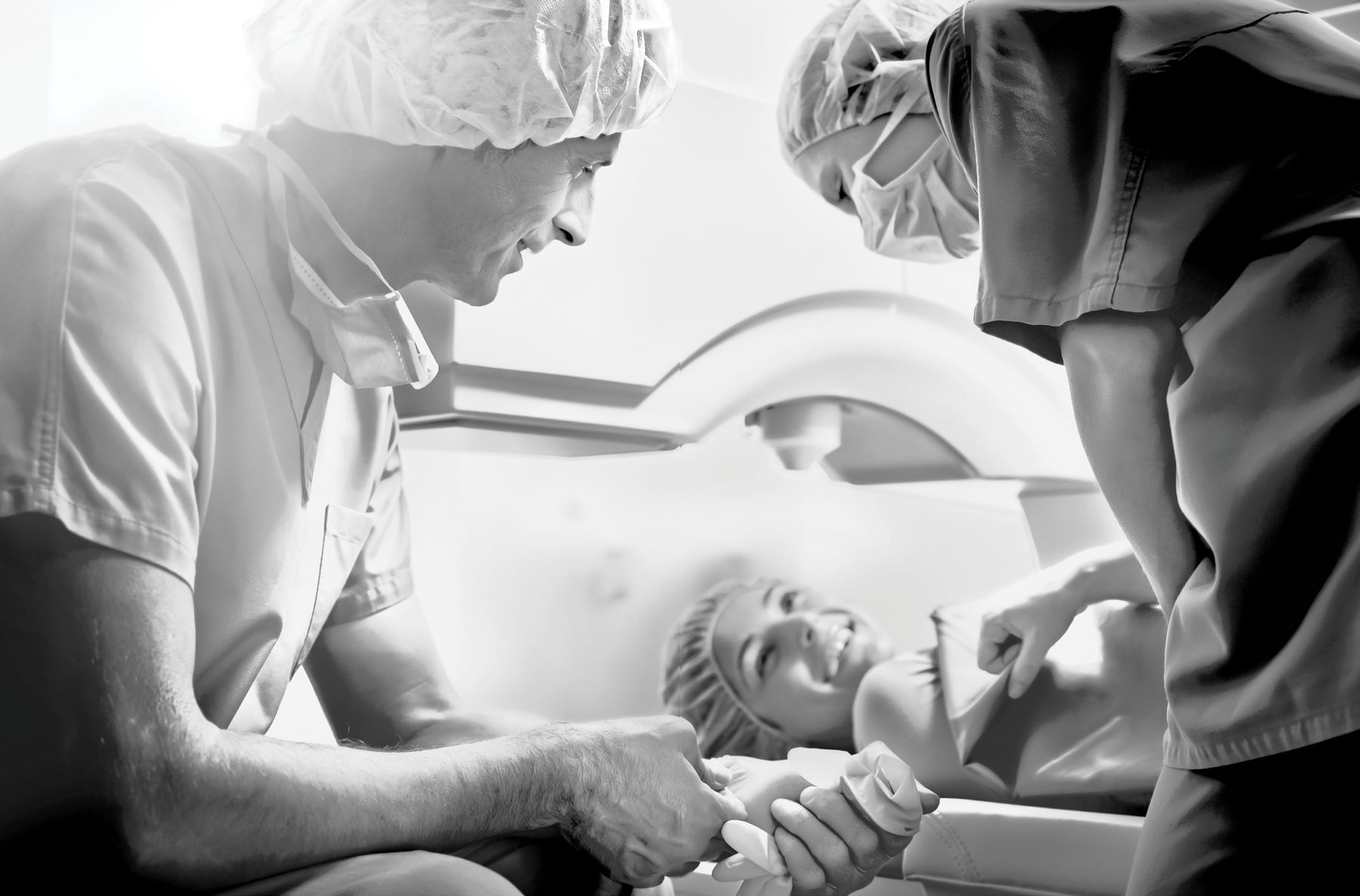 Surgical team reassuring a patient before a laser procedure